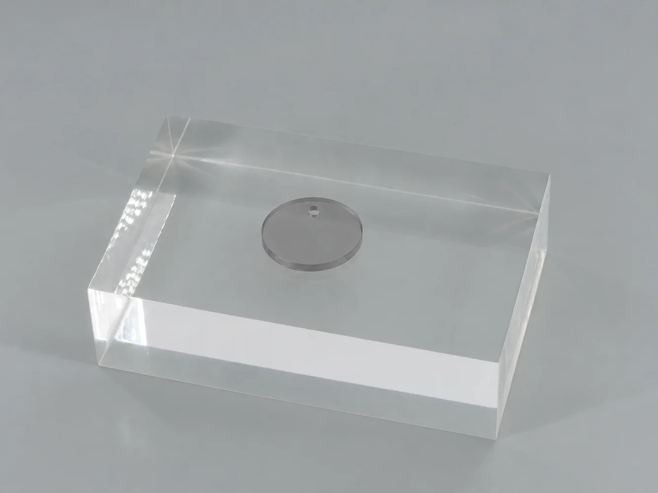 Smoked Gray polycarbonate chip on a clear block (illustrative image)